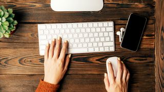 The Apple Magic Keyboard, here on a wooden desk, is one of the best keyboards we've tested.