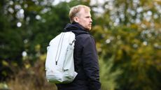 Peak Design Outdoor Backpack 25L in white, on a man's shoulders