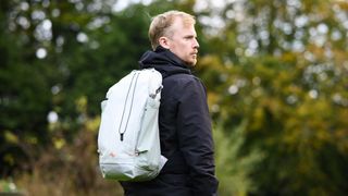 Peak Design Outdoor Backpack 25L in white, on a man's shoulders